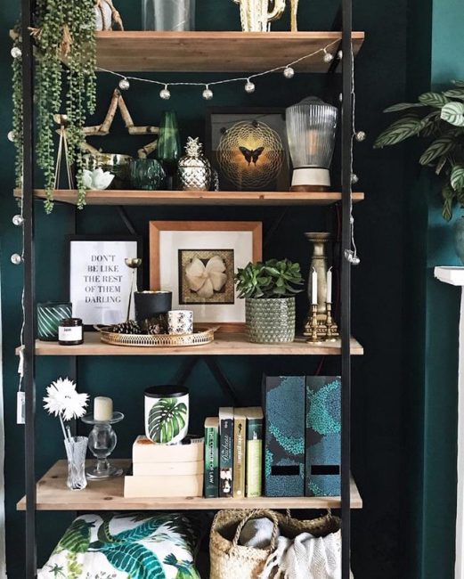 SHELVES AND GOLD DETAILS LOOK AGAINST THIS DARK GREEN WALL SHELVES AND GOLD DETAILS LOOK AGAINST THIS DARK GREEN WALL